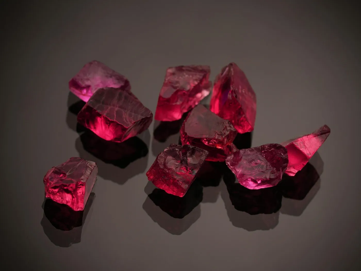 Red gemstones on a dark reflective surface